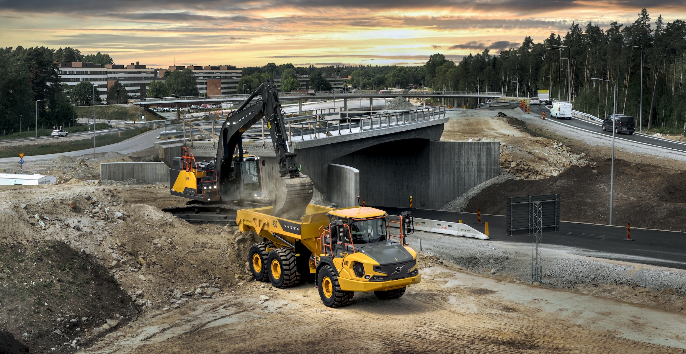 Volvo A30 articulated truck and EC300 crawler excavator on road construction job site.