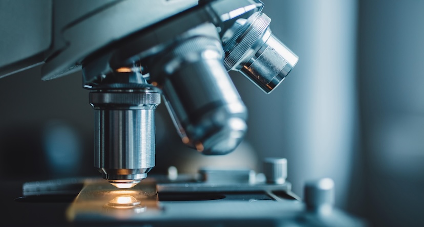 Close-up of a microscope looking at a construction equipment fluid analysis sample.