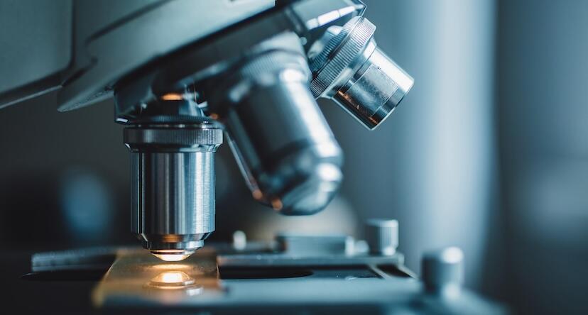 Close-up of a microscope looking at a construction equipment fluid analysis sample.