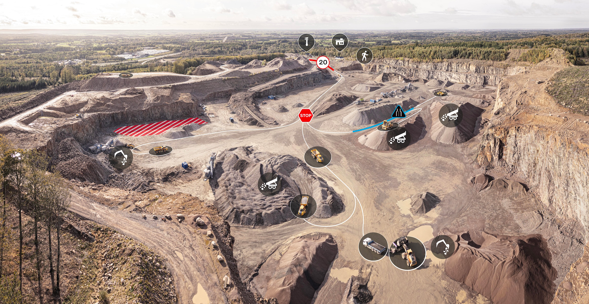 Aerial view of mining equipment and trucks working together in a quarry with icon notifications from Volvo Connected Map visible. 