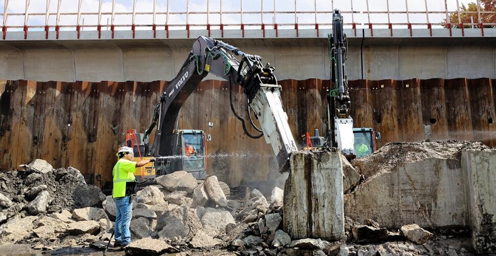 Walsh operators use Volvo excavators to break up a concrete wall as part of the CTA RPM project.