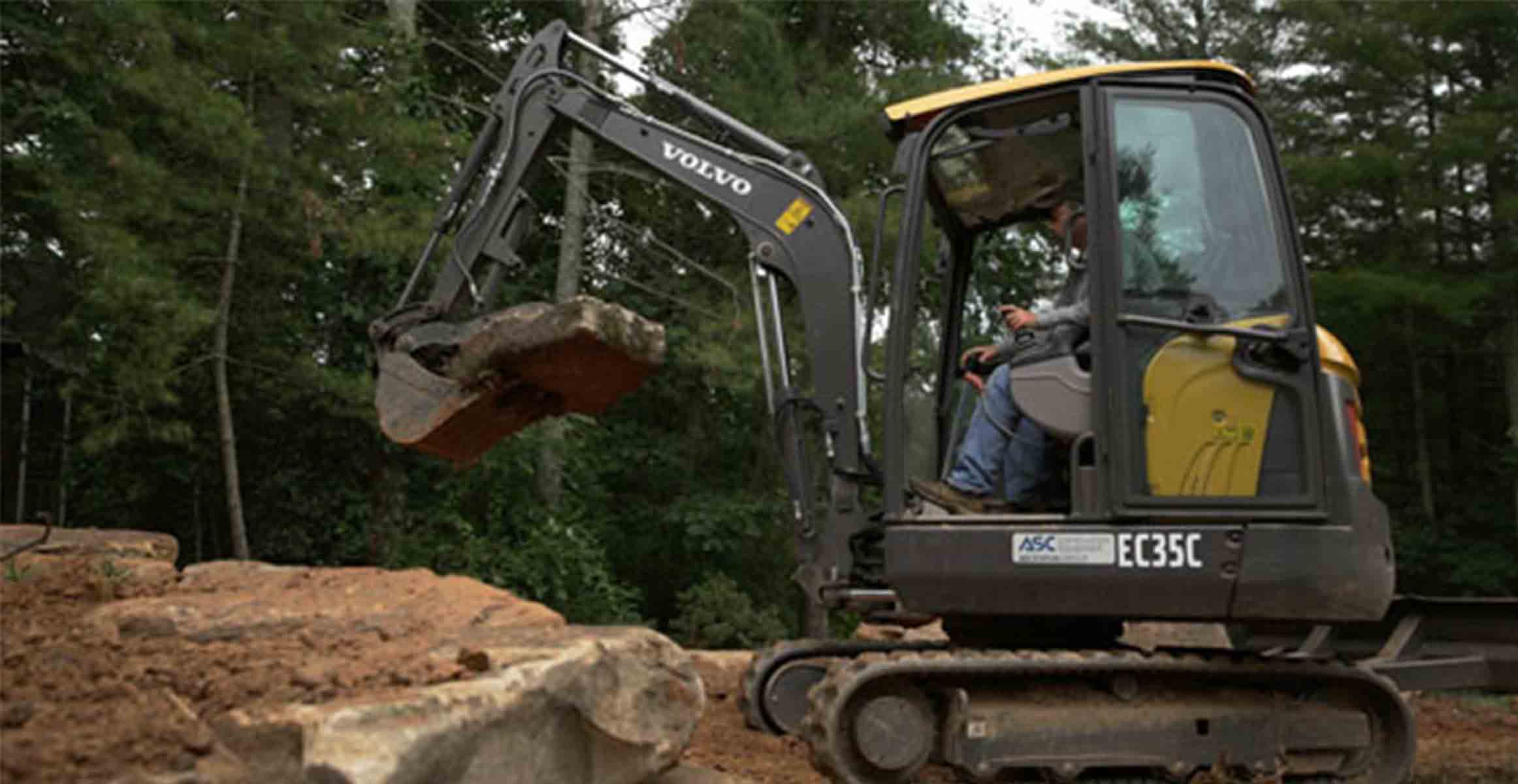 Volvo EC35C mini excavator moving rock for Reese Landscaping Services in Western North Carolina
