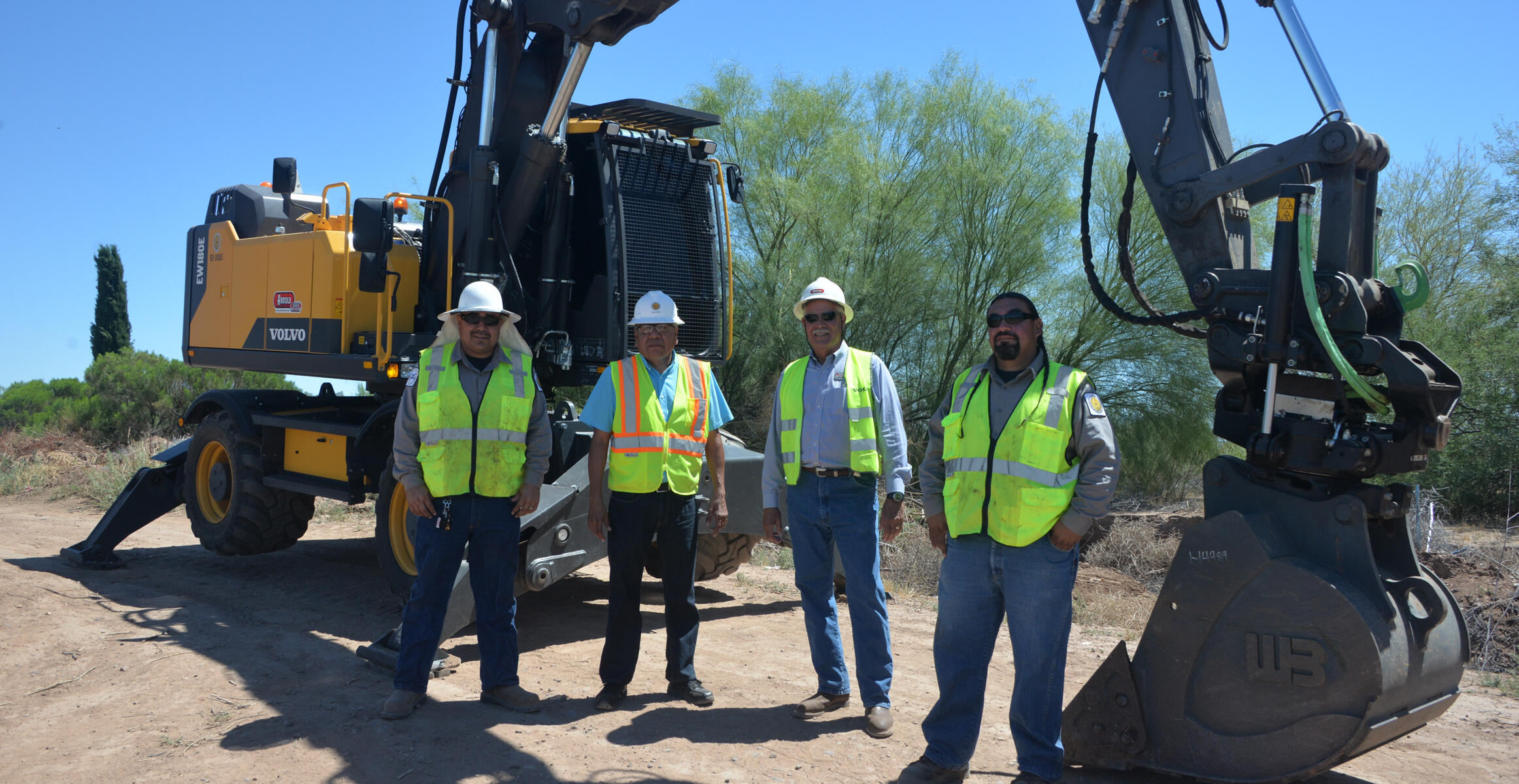 Workers at Salt River PIMA-MARICOPA Indian Community using a Volvo EW180E wheeled excavator