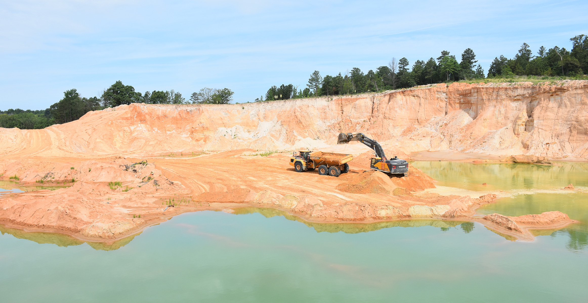 Volvo A60H Articulated Truck and EC750E Crawler Excavator at U.S. Silica quarry
