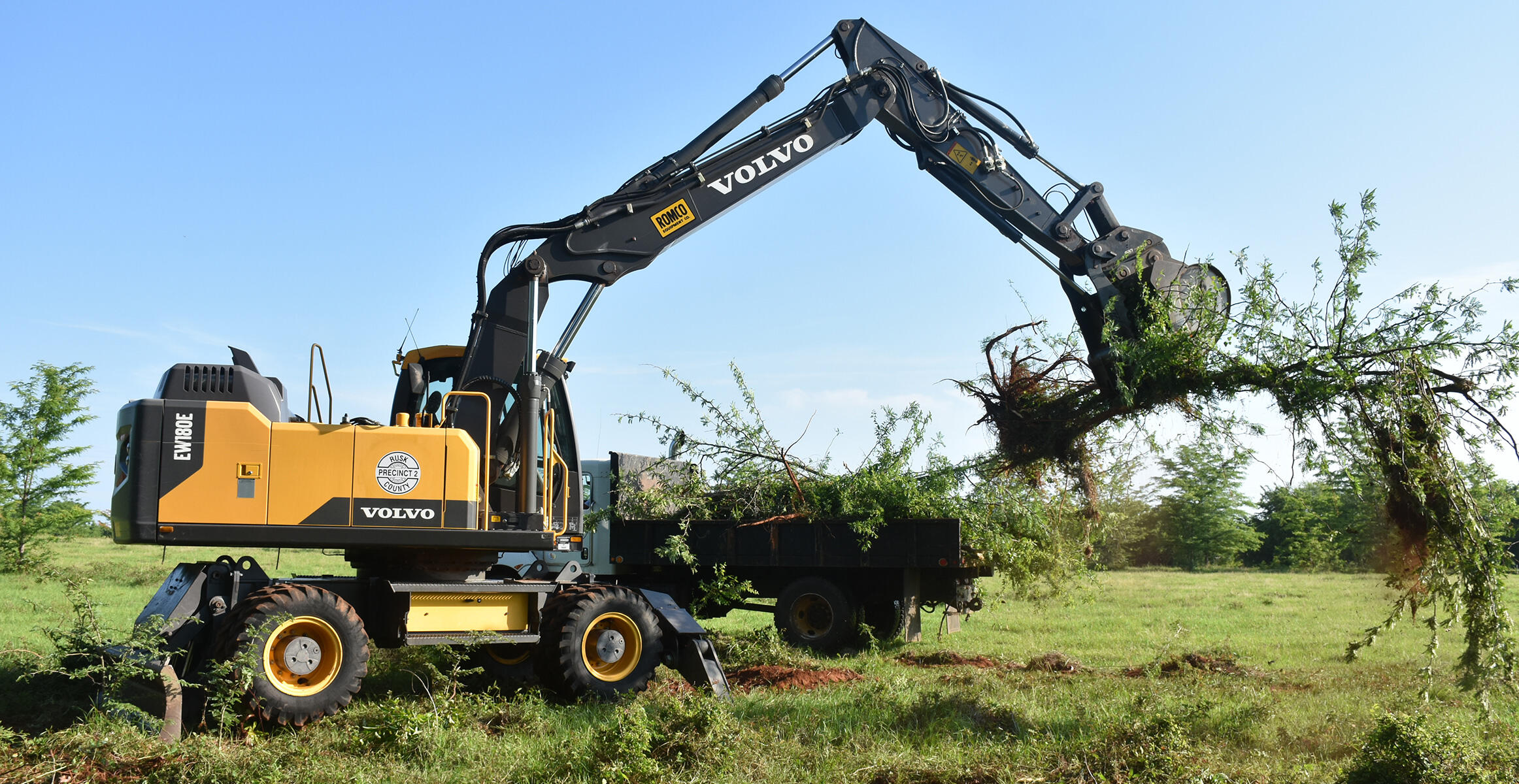 Wheeled excavators used for storm clean-up in Rusk County, Texas