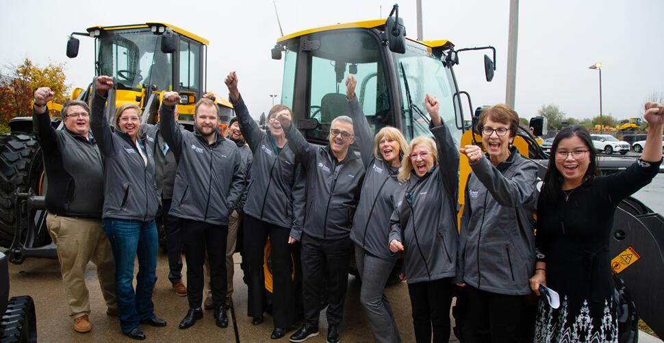 Nors, Volvo and Habitat GTA staff cheer for the delivery of the electric loader.