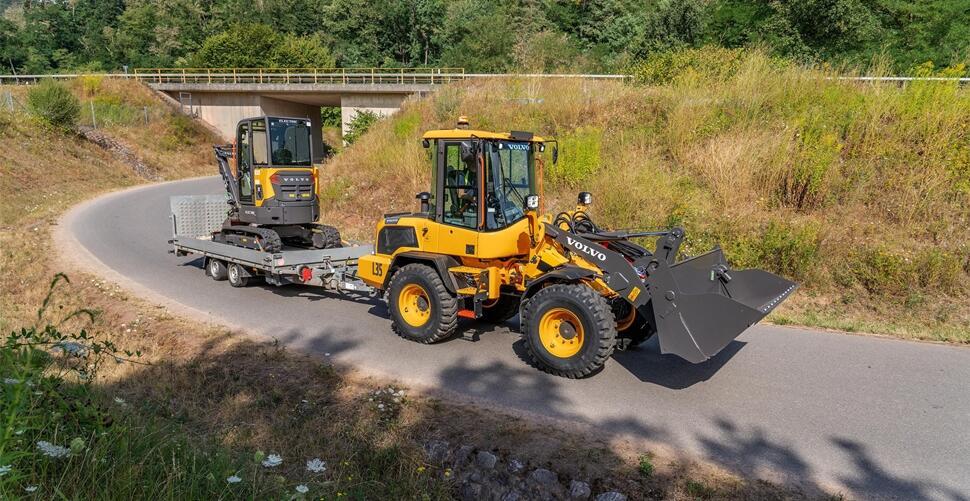Volvo L35 Compact Wheel Loader Towing a Volvo Electric Mini Excavator