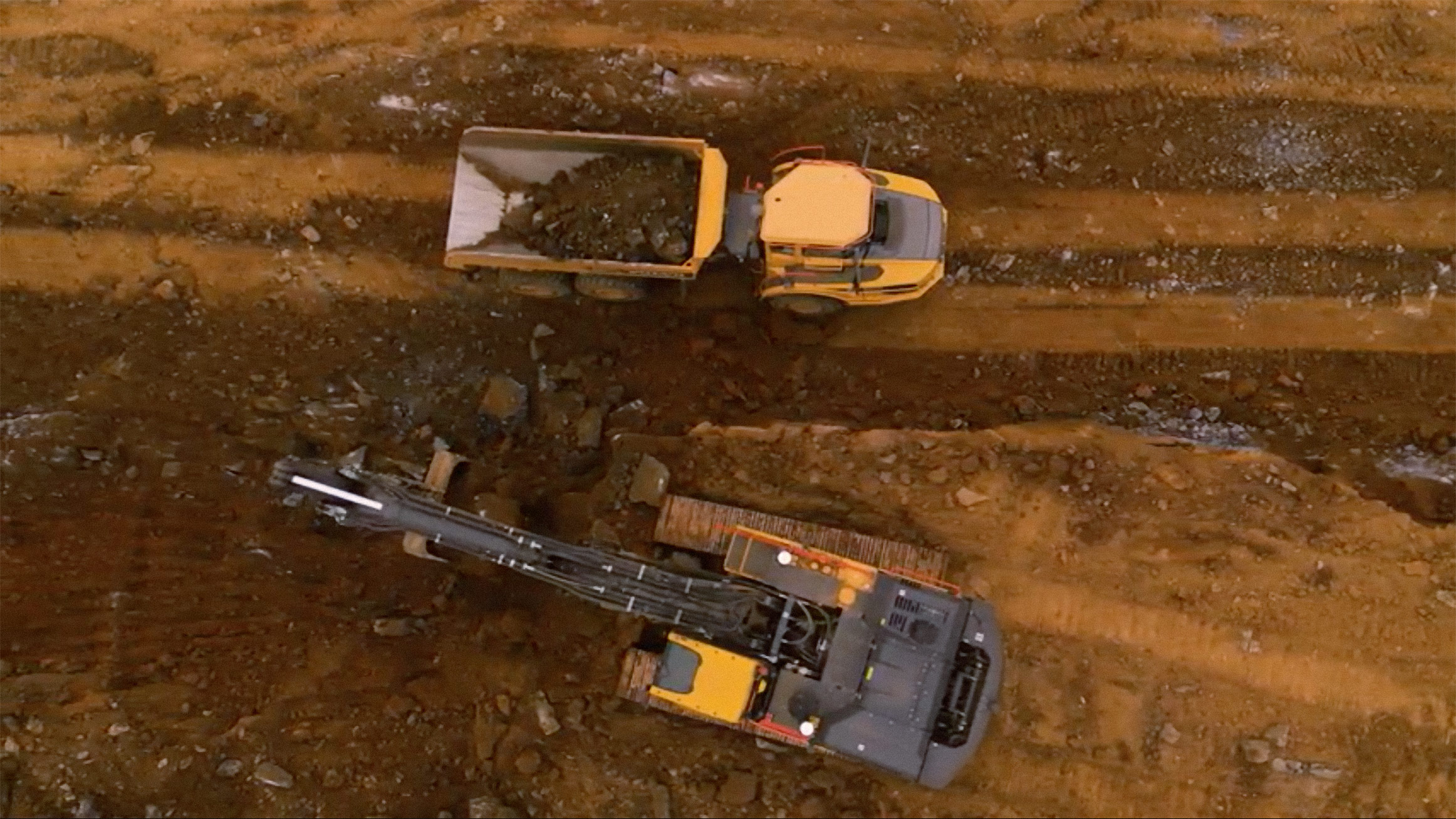 Overview of a Volvo excavator next to a Volvo articulated dump truck.