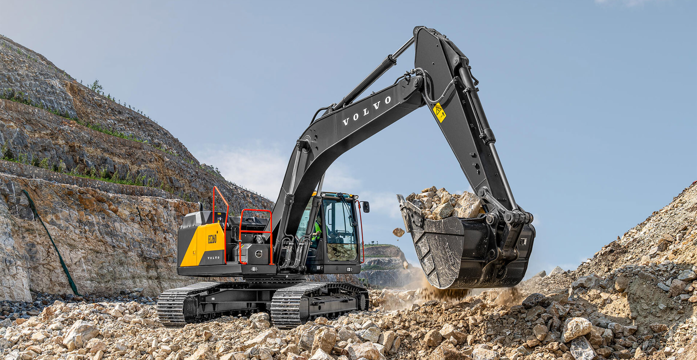 A Volvo EC260 excavator moving rock in a quarry.