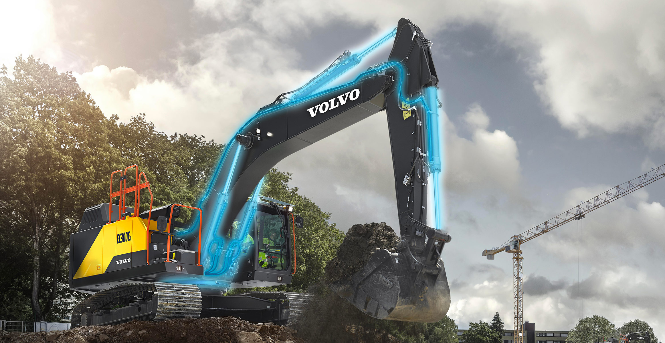 A Volvo EC300 excavator loading dirt on a construction site with the hydraulic lines highlighted in neon blue.