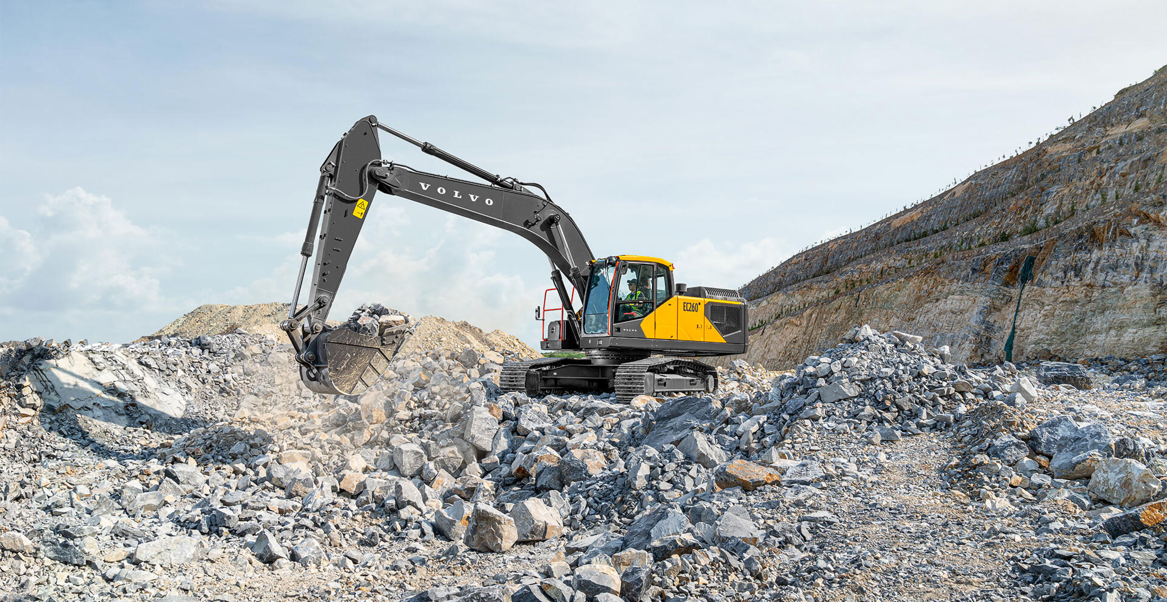 A Volvo EC260 excavator moving rock in a quarry.