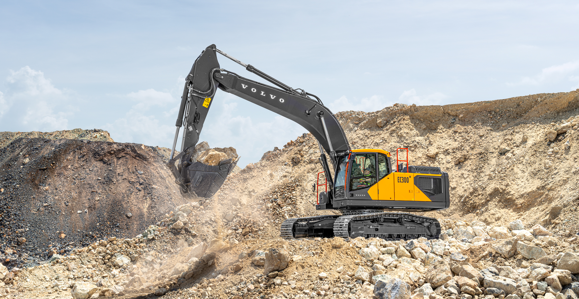 A Volvo EC300 crawler excavator moving rock in a quarry.