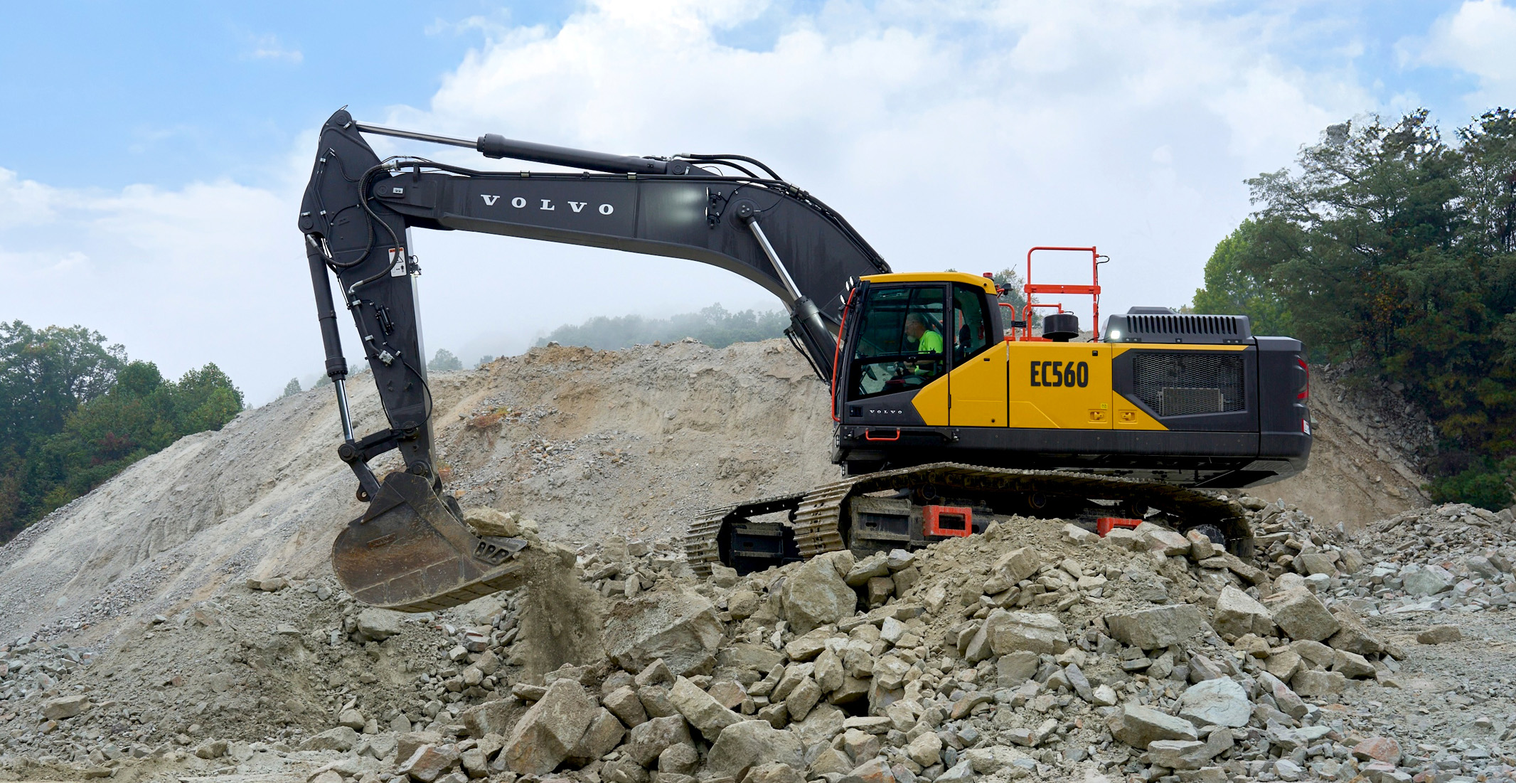 A Volvo EC560 tracked excavator moving rock in a quarry.