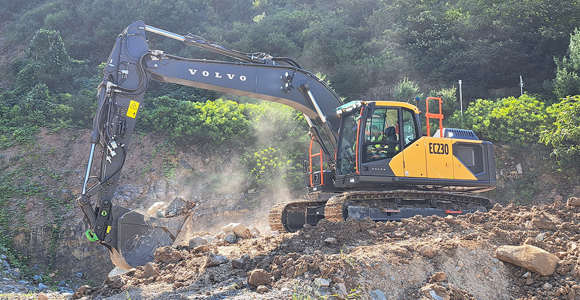 Volvo EC230 excavator moving dirt and rock on a remote jobsite. 
