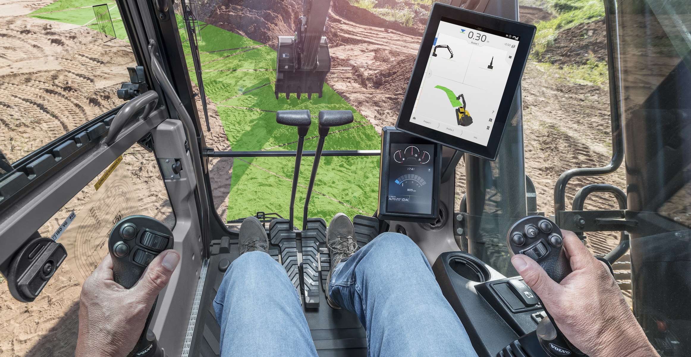 A view out of a Volvo excavator cab with a green Dig Assist line showing a curved pattern to dig.