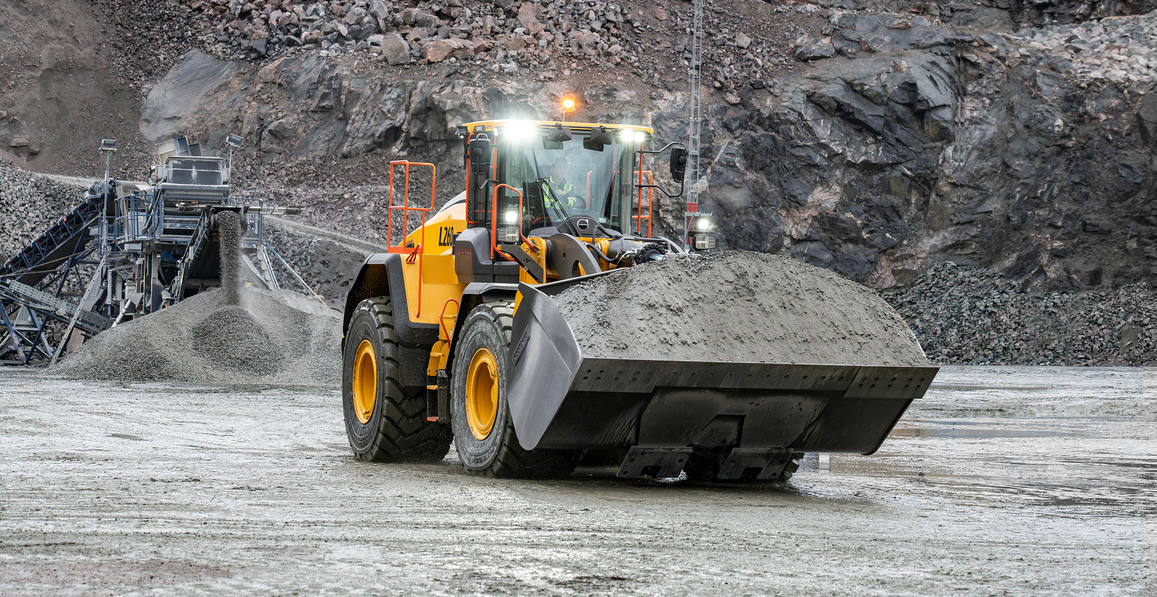 A Volvo wheel loader hauling aggregate for processing.