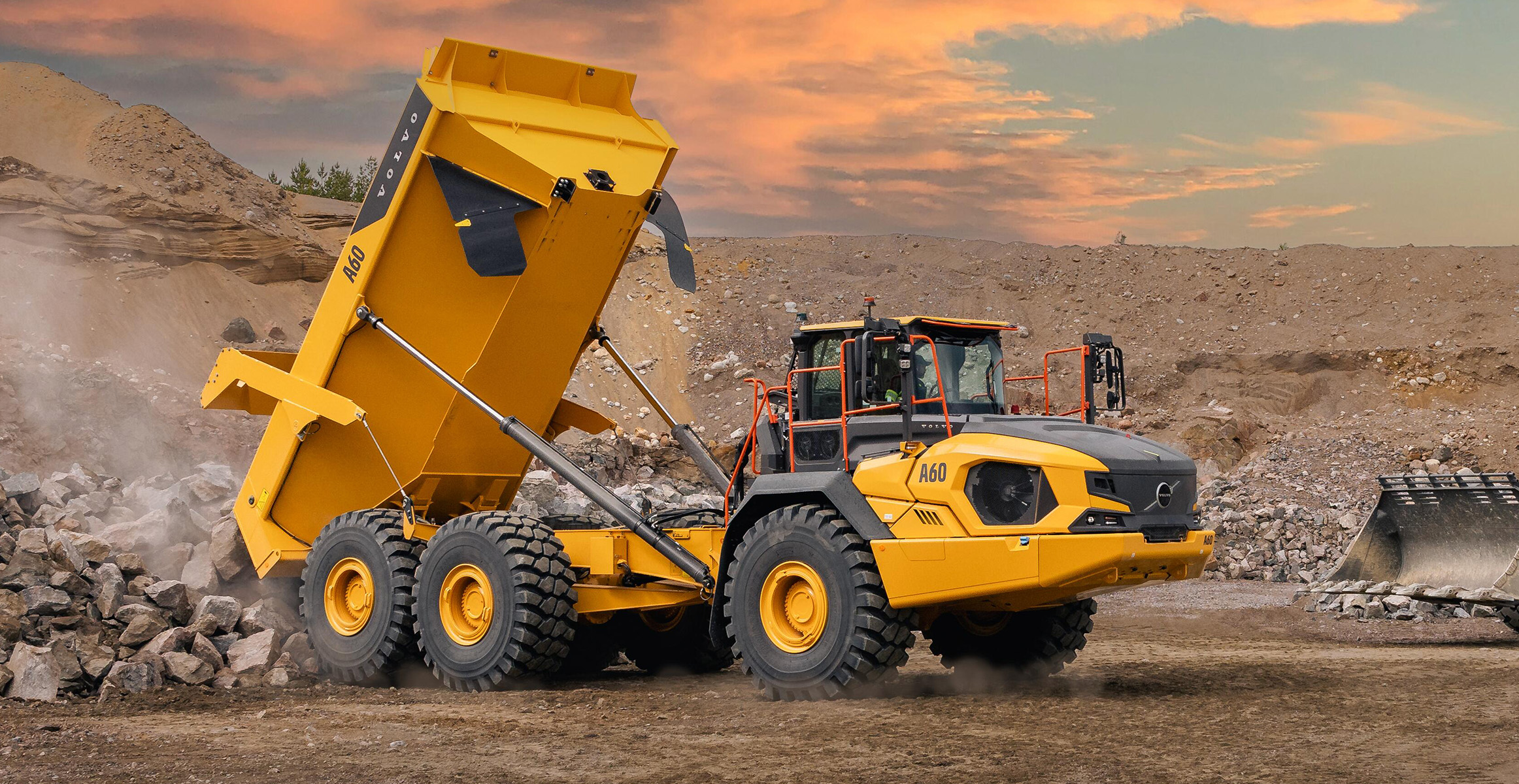 A Volvo A60 articulated haul truck dumping rock in a quarry.