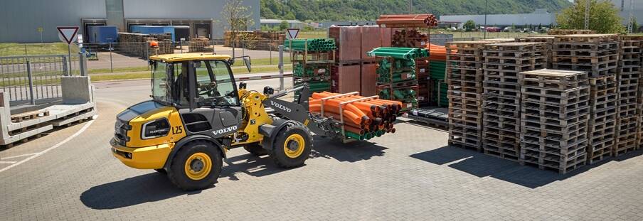 A Volvo L25 Electric wheel loader managing material handling on a jobsite.