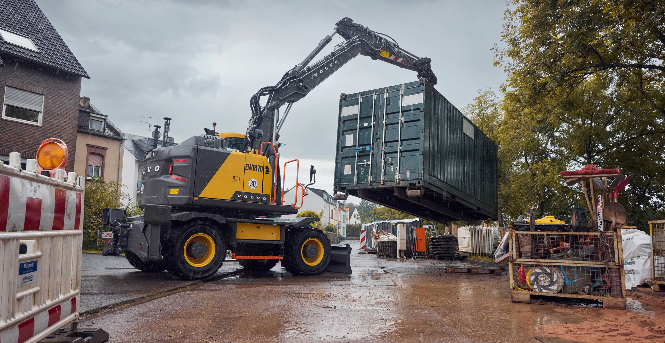 Volvo EWR170 wheeled excavator loading container