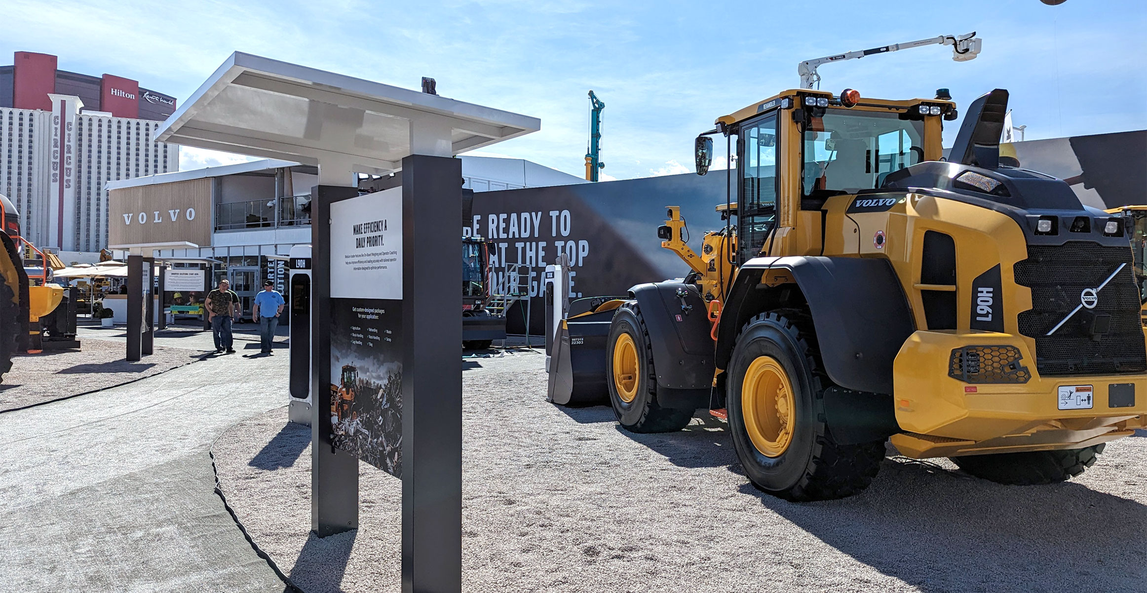 A view of the Volvo CONEXPO booth in 2023, with a Volvo wheel loader in the foreground.