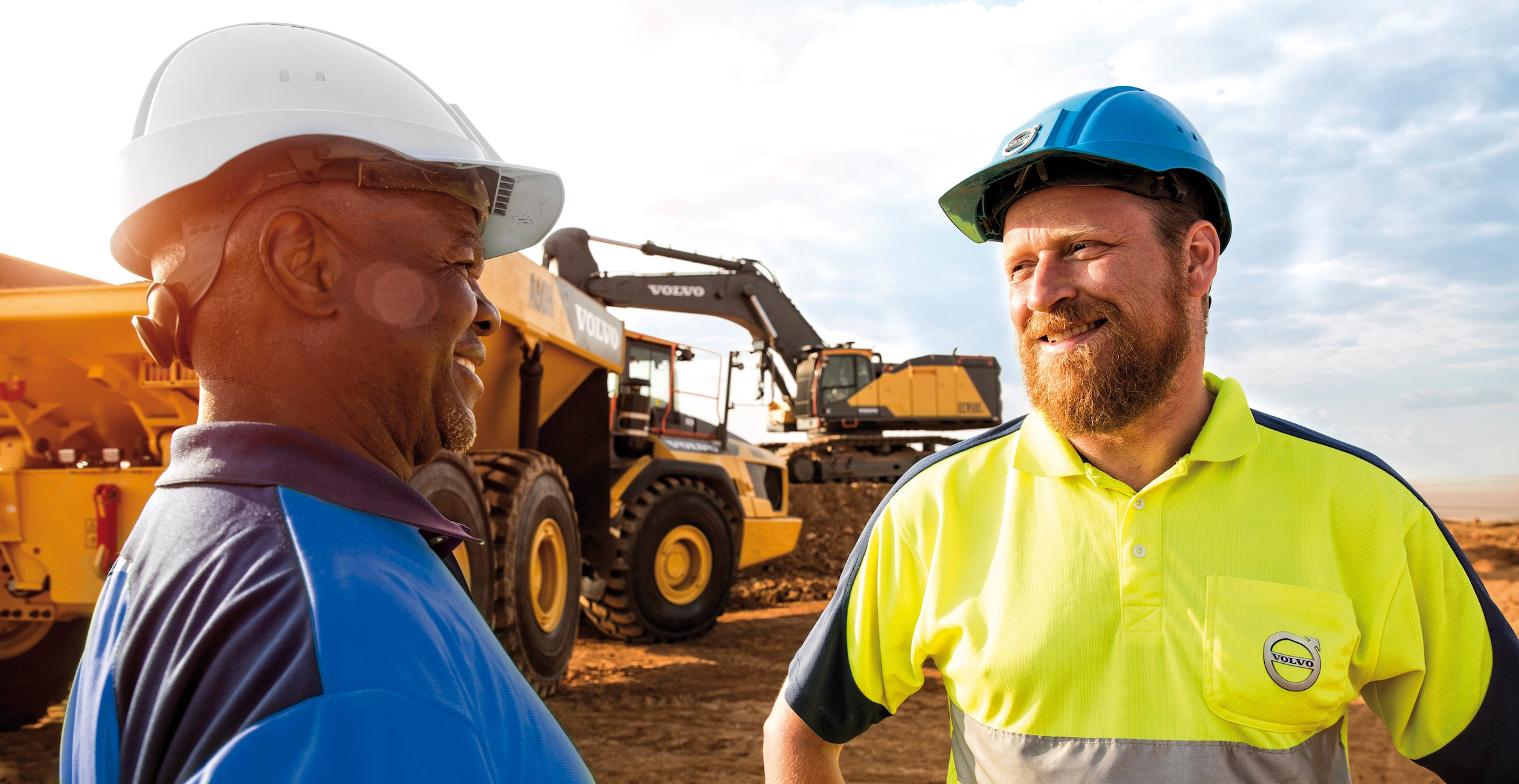 Volvo Services rep talking with a customer on a jobsite