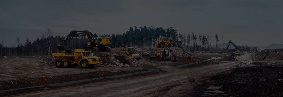 A variety of Volvo construction equipment working together on a jobsite.