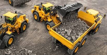 Volvo wheel loaders loading rock into Volvo articulated dump trucks.