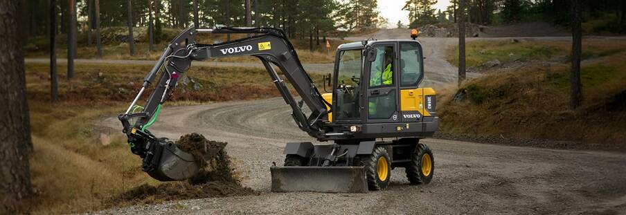 A Volvo wheeled excavator working on street maintenance. 