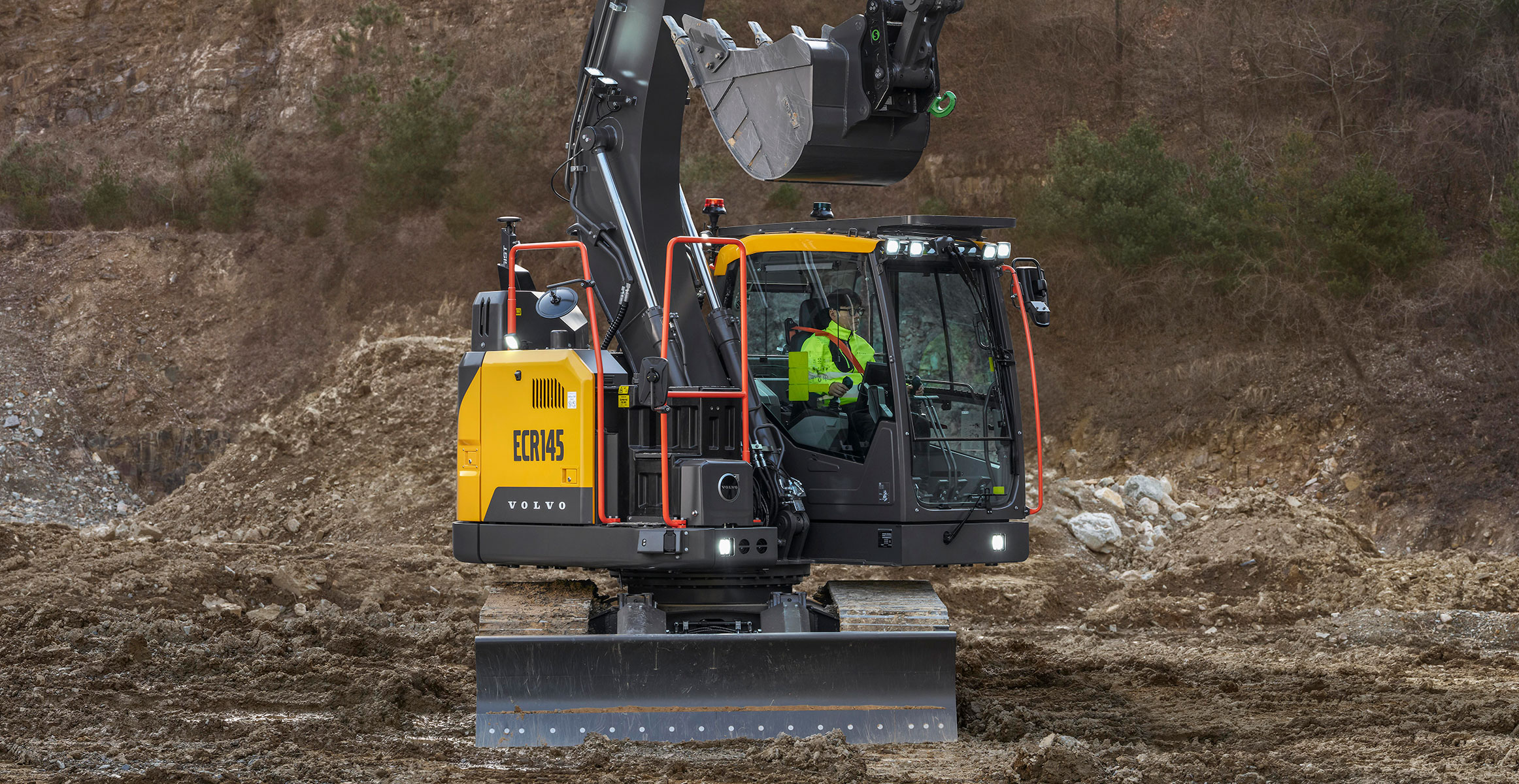 Close-up of a Volvo ECR145 crawler excavator working in a quarry.