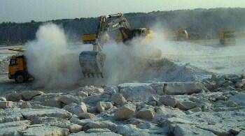 The Volvo excavator breaks up the hard ground