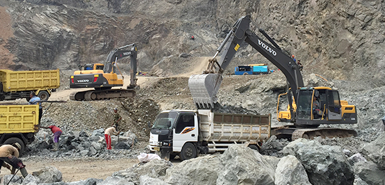 Alam Jaya CV owns three Volvo Construction Equipment vce excavators including two EC210B-Primes and one EC220DL to load the rock onto trucks amid what looks like a lunar landscape