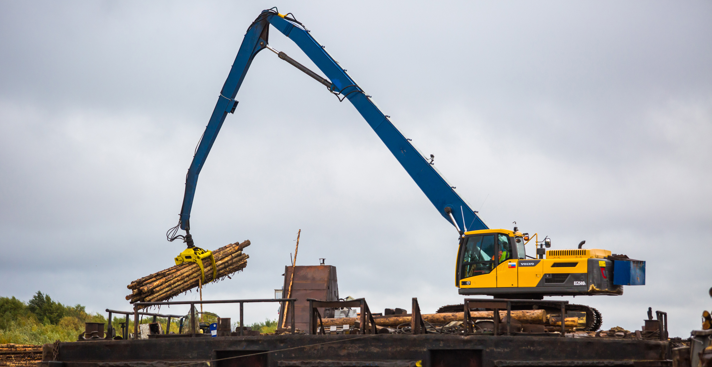 Modified Volvo EC250 excavator with grapple