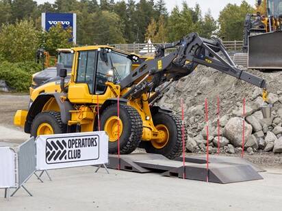 Volvo wheel loader with a lifting attachment at the Volvo Operators Club Final event.