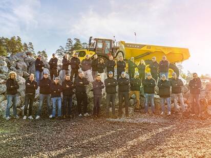 Operators Club Final contestants lined up in front of a Volvo dump truck.