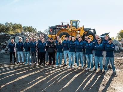 Volvo Operators Club finalists lined-up in front of a Volvo wheel loader.