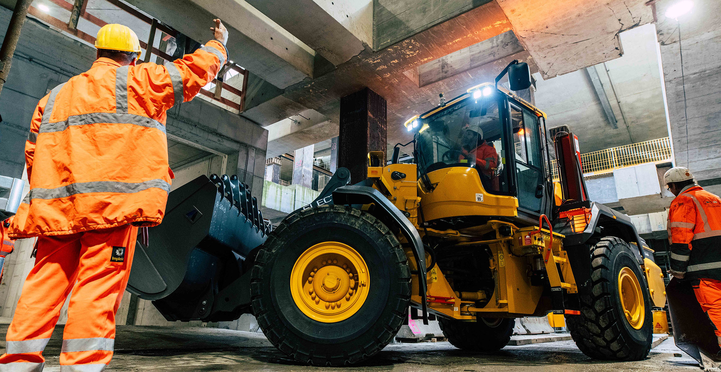 Electric wheel loader doing safe underground construction in Deutsche Bahn tunnel construction project.