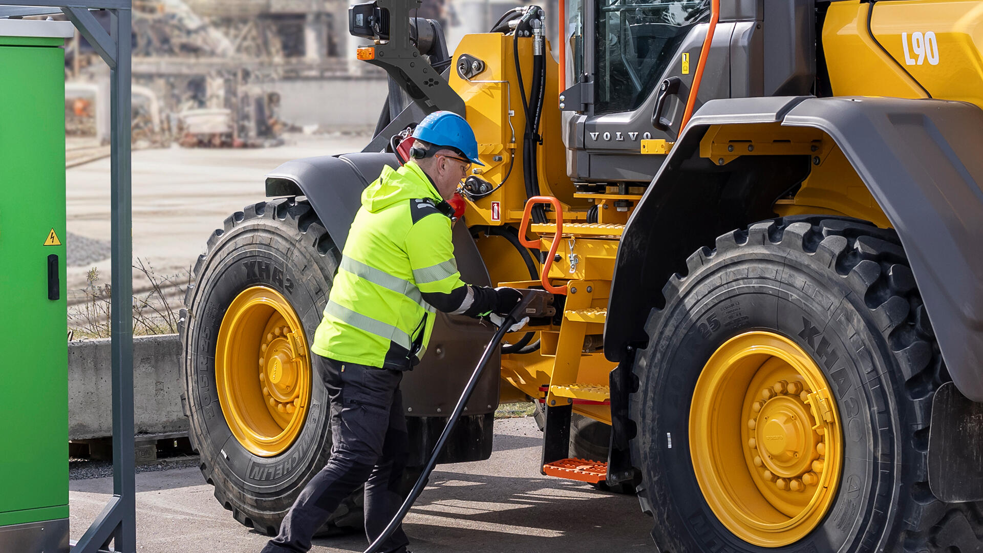 Operator charging Volvo large electric wheel loader.